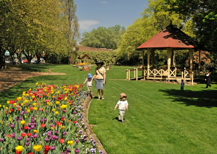 Families walking past tulip beds in a Southern Highlands garden